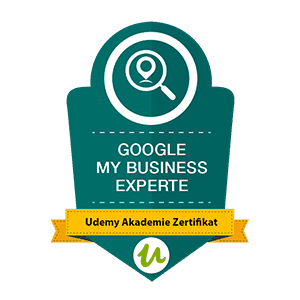 Badge mit der Aufschrift „GOOGLE MY BUSINESS EXPERTE“ mit einem Lupensymbol und einem Udemy Akademie-Zertifikat.
